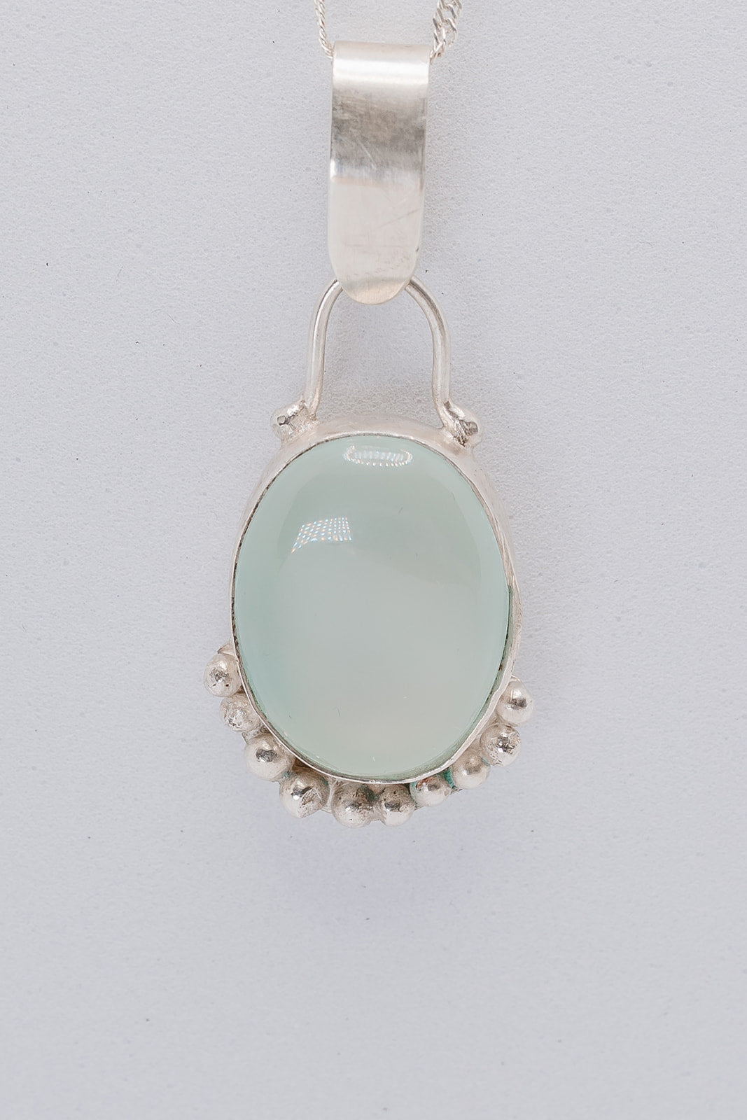 Handmade sterling silver green pendant with silver granulation