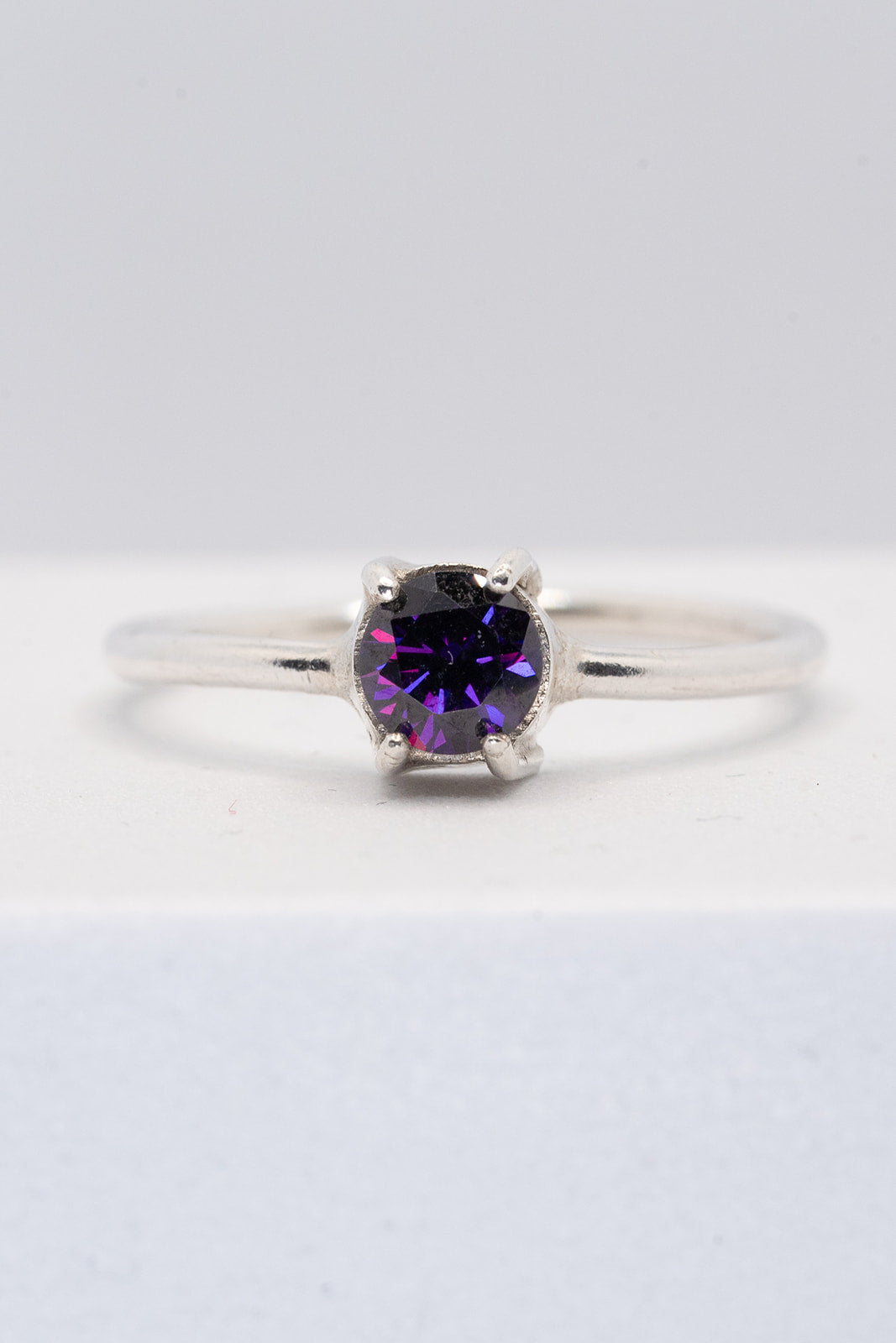 Sterling silver claw ring with purple CZ - size O