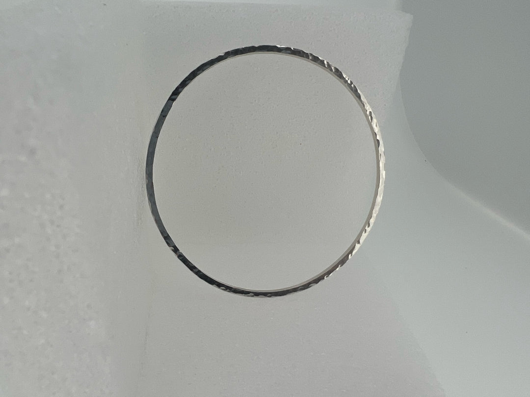 Sterling silver large round hammered stacking bracelet.